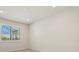 Bright bedroom with a large window with plantation shutters and light tile floors at 13202 Borrego St, Venice, FL 34293