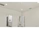 Spacious bedroom with entrances to two bathrooms and light gray tile floors at 13202 Borrego St, Venice, FL 34293