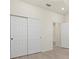 Bedroom features a closet and ensuite bathroom, doors and light-colored flooring at 13202 Borrego St, Venice, FL 34293