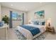 Staged bedroom with a large window and coastal decor and an area rug to add style and comfort at 13202 Borrego St, Venice, FL 34293
