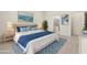 Staged bedroom with a large bed and coastal decor and a view to the ensuite bathroom at 13202 Borrego St, Venice, FL 34293
