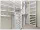 Spacious walk-in closet with custom shelving, drawers, and ample storage space at 13202 Borrego St, Venice, FL 34293