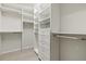Spacious walk-in closet with custom shelving, drawers, and ample storage space at 13202 Borrego St, Venice, FL 34293