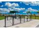 Community dog park featuring separate areas for large and small dogs, with shade and play equipment at 13202 Borrego St, Venice, FL 34293
