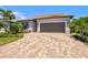 Well-maintained single-Gathering home with paver driveway and lush landscaping at 13202 Borrego St, Venice, FL 34293