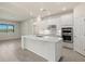 Modern kitchen featuring white cabinets, an island with a sink, and sleek stainless-steel appliances for a contemporary feel at 13202 Borrego St, Venice, FL 34293