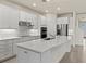 Bright kitchen with an island and stainless-steel appliances, complemented by white cabinetry and modern backsplash at 13202 Borrego St, Venice, FL 34293