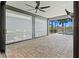 Open lanai with brick pavers, ceiling fan, and views of the outdoor pool at 13202 Borrego St, Venice, FL 34293