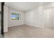 Well-lit living room with large windows and sliding doors leading to outdoor area, with light tile floors at 13202 Borrego St, Venice, FL 34293
