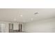 Spacious living area featuring custom shelving, modern lighting, and neutral walls at 13202 Borrego St, Venice, FL 34293