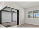 Bright living room with sliding doors to the patio and a large window with white shutters, light tile floors at 13202 Borrego St, Venice, FL 34293