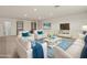 Staged living room featuring couches, blue accents, and recessed lighting at 13202 Borrego St, Venice, FL 34293