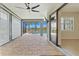 Screened-in patio with outdoor ceiling fan, brick floors, and views of the pool and waterway at 13202 Borrego St, Venice, FL 34293