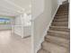Open concept kitchen with granite counters, and staircase with carpeted steps at 13202 Borrego St, Venice, FL 34293