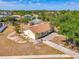 Aerial view of charming home with lush landscaping and mature trees at 13648 Clara Ln, Port Charlotte, FL 33981