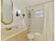 Cozy bathroom with a shower-tub combination, classic vanity, mirror, and decorative accents at 13648 Clara Ln, Port Charlotte, FL 33981