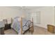 Inviting bedroom features tile floors, large window with blinds and comfortable furniture at 13648 Clara Ln, Port Charlotte, FL 33981