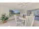 Bright dining room with white table and chairs, large windows, and sliding door to outdoor space at 13648 Clara Ln, Port Charlotte, FL 33981