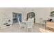 Bright dining room with white table and chairs, large windows, and sliding door to a sunroom at 13648 Clara Ln, Port Charlotte, FL 33981