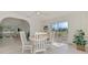 Bright dining room with white table and chairs, large windows, and sliding door to outdoor space at 13648 Clara Ln, Port Charlotte, FL 33981