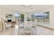 Bright dining room with white table and chairs, large windows, and sliding door to outdoor space at 13648 Clara Ln, Port Charlotte, FL 33981