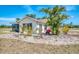 Charming exterior of a house with a screened patio and lush landscaping at 13648 Clara Ln, Port Charlotte, FL 33981