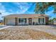 Charming single-story home featuring stone accents, a well-maintained lawn, and inviting curb appeal at 13648 Clara Ln, Port Charlotte, FL 33981