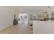 Bright kitchen with white cabinetry, stainless appliances, and open floor plan to dining area at 13648 Clara Ln, Port Charlotte, FL 33981