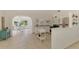 Bright kitchen featuring white cabinetry, stainless steel appliances, and a unique round window above the sink at 13648 Clara Ln, Port Charlotte, FL 33981
