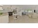 Open-concept layout featuring kitchen with stainless steel appliances flowing into a cozy living room at 13648 Clara Ln, Port Charlotte, FL 33981