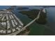 Expansive aerial view of waterfront community, highlighting stylish homes, a bridge, and beautiful bay views at 140 Hermes Rd, Venice, FL 34293
