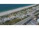 Beautiful aerial view of sandy beach, parking areas, and amenities perfect for a day of seaside fun at 140 Hermes Rd, Venice, FL 34293