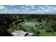 Beautiful aerial view of the property, featuring a serene lake with white sand and lush landscaping surrounding it at 140 Hermes Rd, Venice, FL 34293
