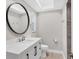 Bathroom featuring a round mirror, vanity with modern hardware, and tiled shower at 140 Hermes Rd, Venice, FL 34293