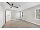 Bedroom with wood floors, a ceiling fan, and a view into the kitchen through an open doorway at 140 Hermes Rd, Venice, FL 34293