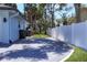 Spacious paver driveway with a view of the white vinyl fenced-in yard providing privacy at 140 Hermes Rd, Venice, FL 34293