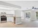 Open kitchen features granite countertops, stainless appliances, and access to the living room at 140 Hermes Rd, Venice, FL 34293