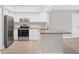 Modern kitchen features white cabinets, stainless steel appliances, and granite countertops at 140 Hermes Rd, Venice, FL 34293