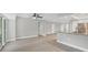 Spacious, airy living room featuring wood floors and an open plan kitchen with stainless steel appliances at 140 Hermes Rd, Venice, FL 34293