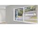 Bright living room features a window with blinds overlooking the yard at 140 Hermes Rd, Venice, FL 34293