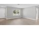 Bright living room features wood-look floors, a window, and neutral paint at 140 Hermes Rd, Venice, FL 34293