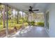 Relax on this screened in porch with a ceiling fan offering views of the landscaped backyard at 140 Hermes Rd, Venice, FL 34293