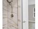 Close up of a marble tiled shower with modern fixtures at 140 Hermes Rd, Venice, FL 34293
