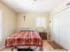 Cozy bedroom with a window, closet, and a wooden cross on the wall at 14124 Kewanee Ln, Port Charlotte, FL 33981
