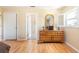 Bright bedroom featuring a window, hardwood floors, and a dresser at 14124 Kewanee Ln, Port Charlotte, FL 33981
