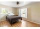 Well lit bedroom with a ceiling fan and a view of the outdoor scenery from the windows at 14124 Kewanee Ln, Port Charlotte, FL 33981