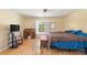 Bedroom featuring a desk by the window, a television, and hardwood floors at 14124 Kewanee Ln, Port Charlotte, FL 33981