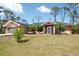 Charming single-story home features an attached garage, mature landscaping, and front bench at 14124 Kewanee Ln, Port Charlotte, FL 33981