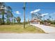 Front view of the home and driveway with a large lot at 14124 Kewanee Ln, Port Charlotte, FL 33981