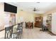 Open-concept living room with a breakfast bar, dining area, desk and hutch combination, and stainless steel appliances at 14124 Kewanee Ln, Port Charlotte, FL 33981